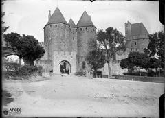 Ancient city walls and towers of Carcassonne with a horse-drawn cart and a man