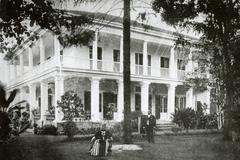 Queen Liliuokalani standing outside Washington Place with Captain Samuel Nowlein