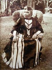 Closeup portrait of Queen Liliuokalani sitting on lawn outside Washington Place