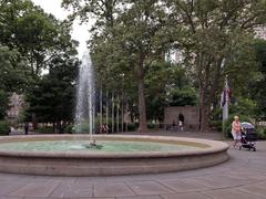 Low circular fountain with water plume in urban park near Tomb of the Unknown Soldier of the American Revolution