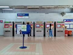 Interior view of the Gombak LRT Station concourse with escalators and signage in Selangor