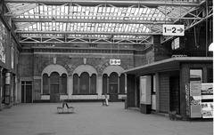 Interior concourse of Broad Street station looking west with the former refreshment room and a North London Railway 4-4-0 tank model in a glass case