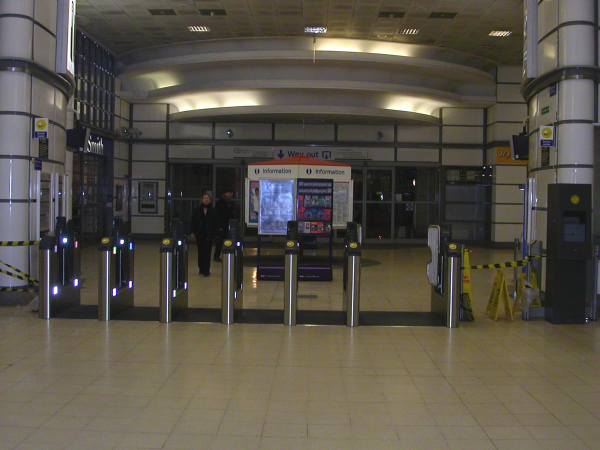 Ludgate Hill concourse at City Thameslink station with commuters and exit signs
