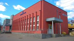 Naujoji Vilnia train station building with clock tower and railway tracks
