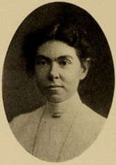Portrait of a white woman with dark hair in high-collared white lace blouse and oval frame