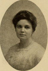 Young white woman with dark hair in an updo wearing a white lace-trimmed shirtwaist in an oval frame
