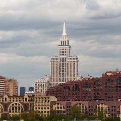 West view of Triumph Palace in Moscow with the red-yellow Marshal Residential Complex below on Rybalka Street