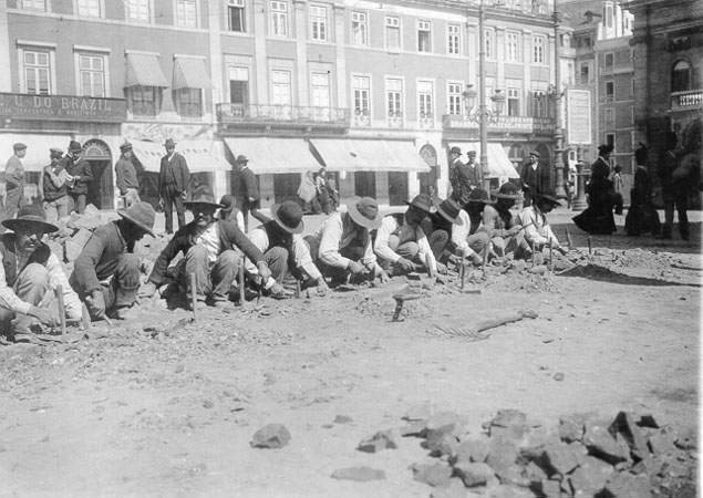 Calceteiros working on traditional pavement in Lisbon