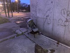 Abandoned baby carriage in urban setting