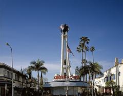 Crossroads of the World building in Los Angeles at dusk with neon lighting