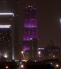 Bank of America Tower in downtown Miami illuminated with purple lights at night