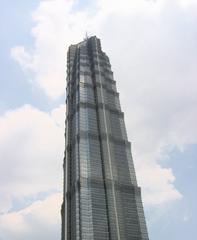 Jin Mao Tower in Shanghai at sunset with glowing lights
