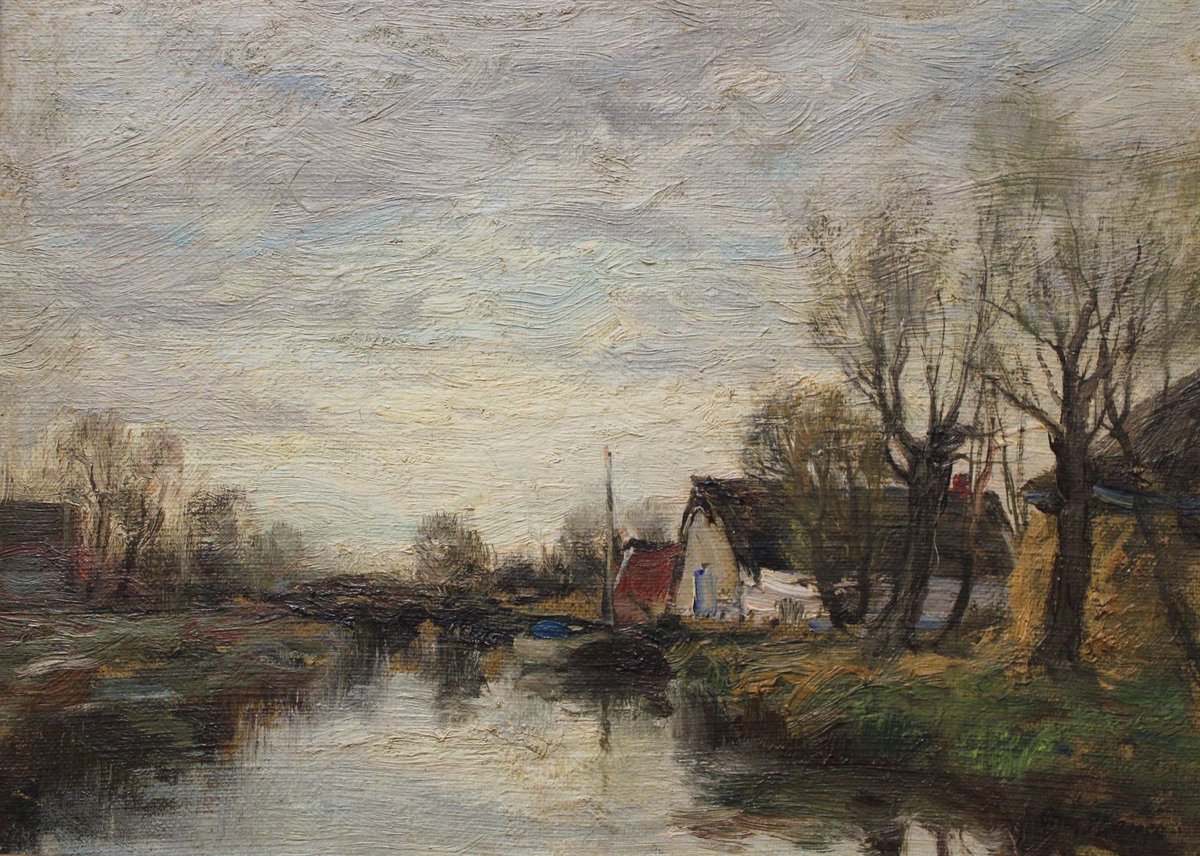 Peaceful canal scene at Voorburg in Holland showing traditional Dutch houses and boats