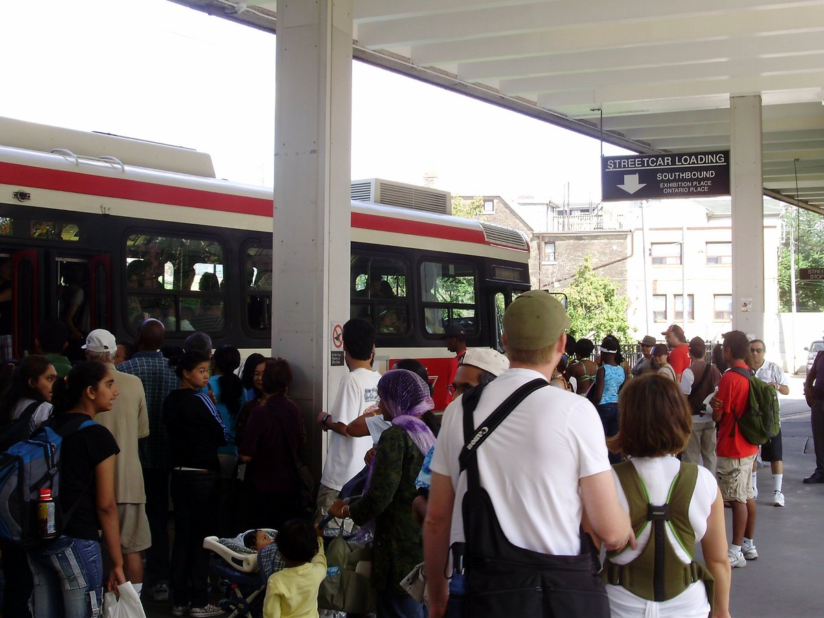 Passengers boarding an articulated light rail vehicle at Bathurst station during Caribana 2008 in Toronto