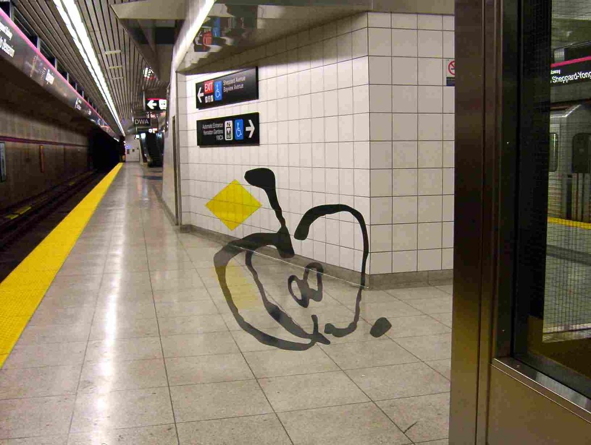 Bayview TTC subway station platform in Toronto with blue and white tiles and train tracks