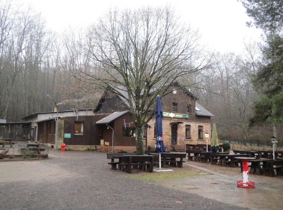 Scenic mountain lodge Naturfreundehaus Kirschheck nestled in snowy pine forest