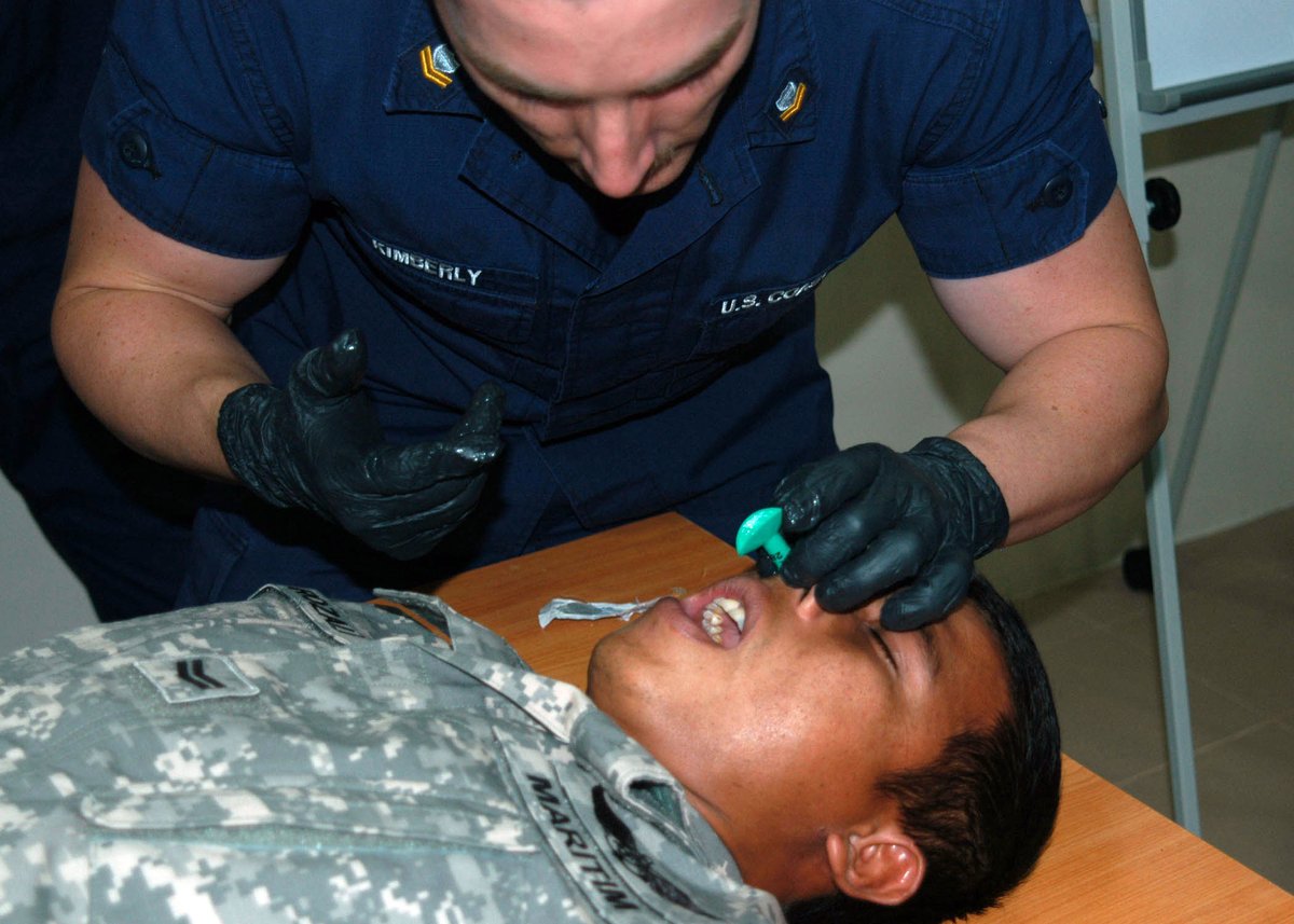 U.S. Coast Guard EMT demonstrating emergency nasopharyngeal airway insertion during CARAT Malaysia 2011 training