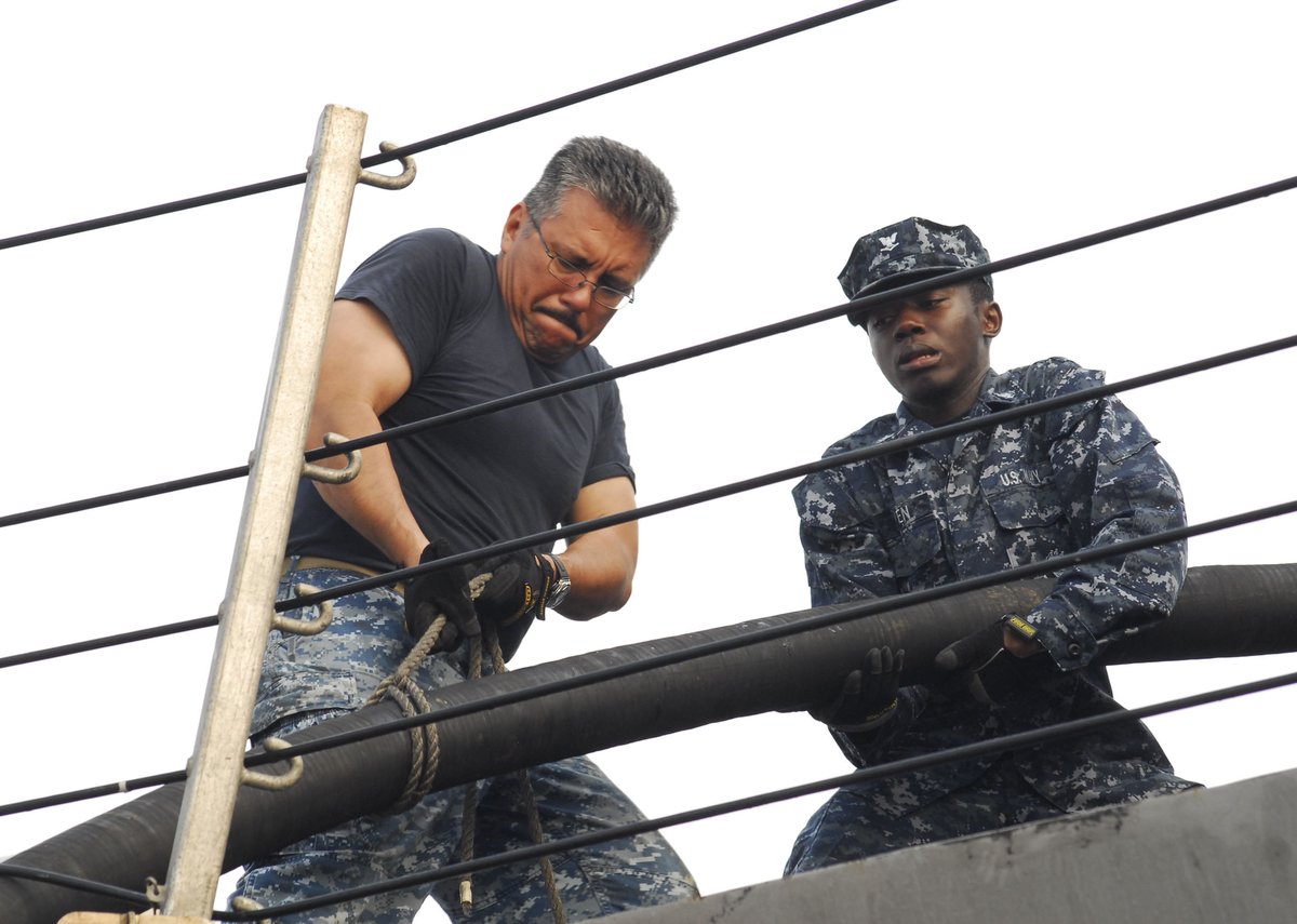 U.S. Sailors aboard USS Freedom hauling potable water cable line after maritime exercises with Royal Malaysian Navy during CARAT Malaysia 2013
