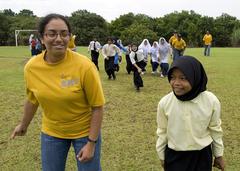 Seaman Katherine Santos-Perez from USS Chung-Hoon playing red-light green-light with Malaysian children at Seberan Tayor Primary School during CARAT Malaysia 2009
