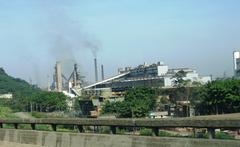 Aerial view of Companhia Siderúrgica Paulista (COSIPA) steel manufacturing plant with industrial buildings and smokestacks