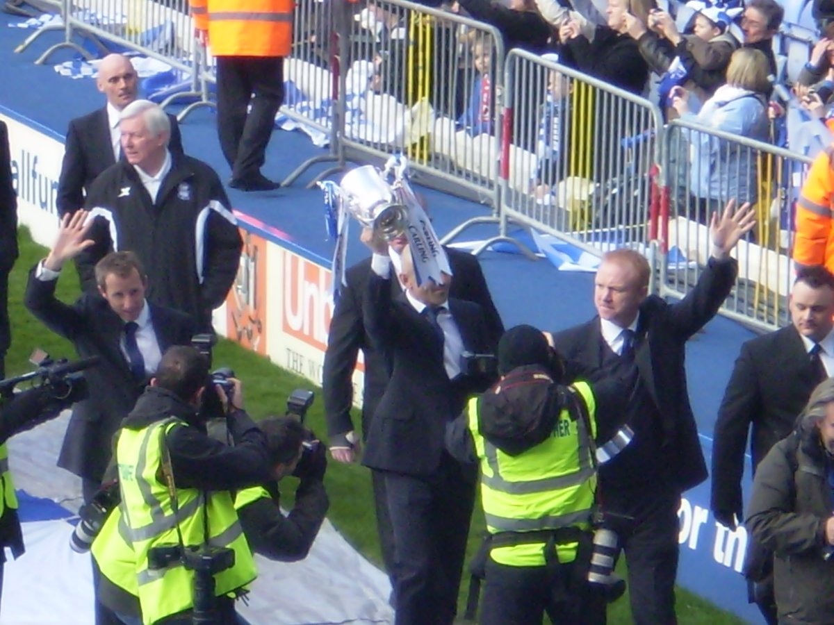 Birmingham City F.C. players Lee Bowyer and captain Stephen Carr with manager Alex McLeish parade the 2011 League Cup in front of fans at St Andrew's stadium
