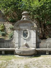 Luisenbrunnen fountain in Saarbrücken with greenery and historic buildings