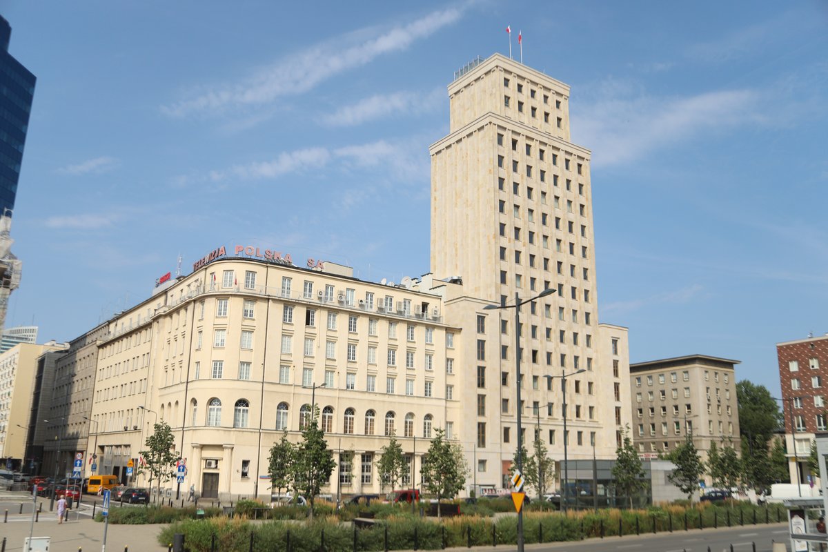 August cityscape of Warsaw with modern and historic buildings under clear blue sky