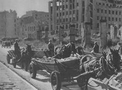 Debris removal at the corner of Mazowiecka and Świętokrzyska streets in Warsaw with Prudential building on the right