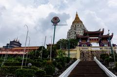 View of Kek Lok Si Temple in Penang with pagoda and greenery under cloudy sky