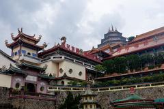 Kek Lok Si temple in Penang with its multi-tiered pagoda towering over lush greenery under a clear blue sky