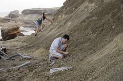 Terry Lopez and Noa Dettweiler collecting bird fossils at Ki’i Point Beach near Kaneohe Bay Range Training Facility