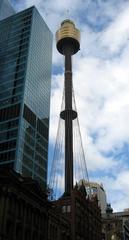 Sydney Tower illuminated at night with city lights in the background