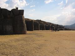 Saksayhuaman archaeological site near Cusco with massive stone walls under blue sky