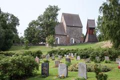 Historic Gamla Uppsala Church in Sweden under a bright blue sky