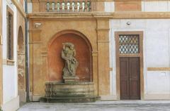 Fountain with Hercules statue on the left side in the courtyard of the Tuscan Palace in Prague