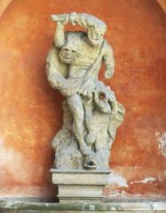 Historic fountain with statue of Hercules in courtyard of the Tuscan Palace, Prague