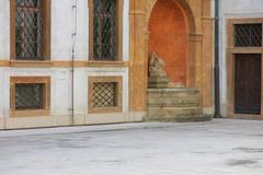 Fountain with fish sculpture on the right side in the courtyard of the Tuscan Palace in Prague