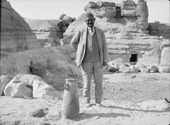 Dr. Selim Bey Hassan showing a pottery jar from excavations near the fourth pyramid in Egypt