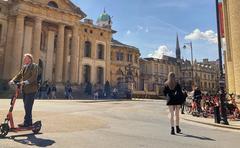 Broad Street in Oxford city with people walking and buildings on either side in the year 2025