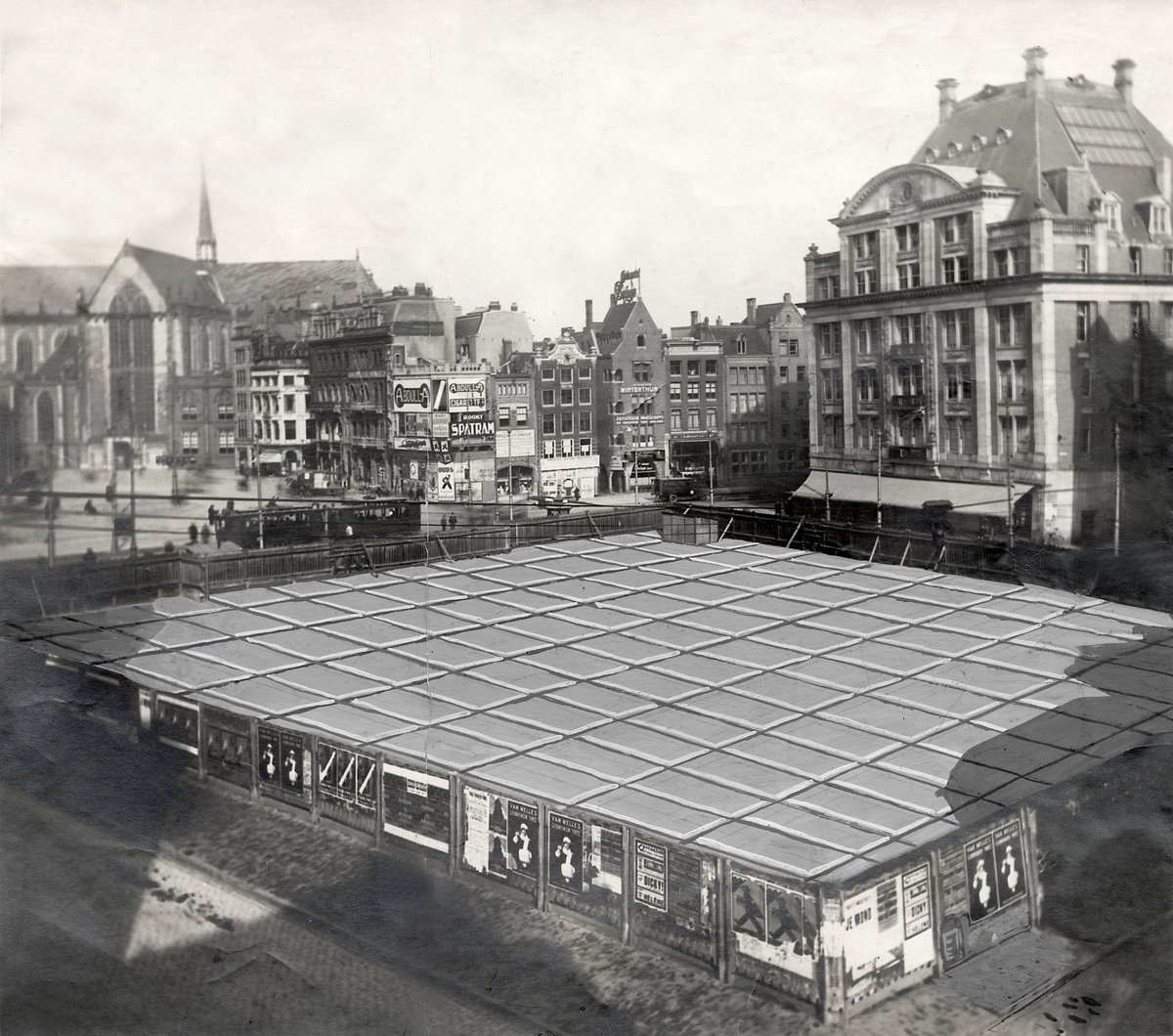 Historical image of Dam Square in Amsterdam with retouched floor heating tiles under construction in 1923 April Fools prank