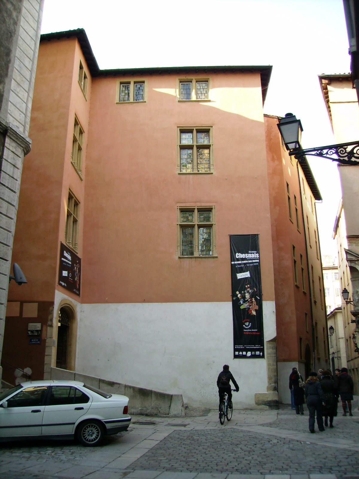 Entry of Gadagne Museum Lyon with wooden door and stone arches