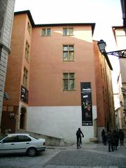 Entry of Gadagne Museum Lyon with wooden door and stone arches