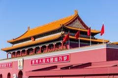 Tiananmen Gate in Beijing with blue sky and red flags