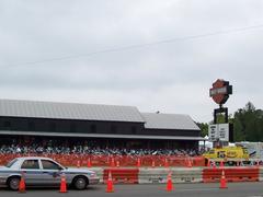 Harley-Davidson motorcycle rally with large crowd of bikers gathered outdoors