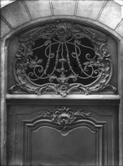 Wrought iron transom with floral and curved patterns