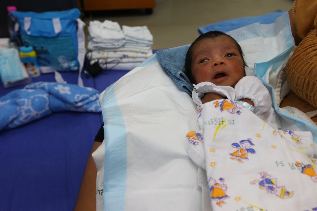 A 10 day old infant held by U.S. Marines during humanitarian aid assessment in Bangkok flood relief