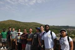 Sailors from Naval Support Activity Naples standing on top of the historic Caroline Aqueducts in Maddaloni during a community service event