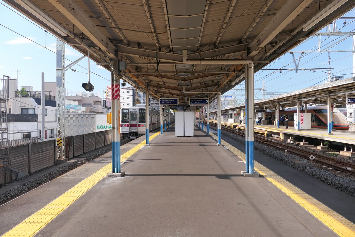 Platforms 1 and 2 of Tobu Railway Hikifune Station Isesaki Line with train and overhead roof