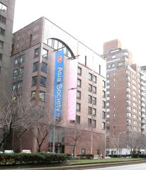 View of Asia Society building across Park Avenue on a cloudy afternoon