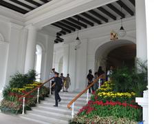 Istana presidential residence in Singapore surrounded by lush greenery and a clear sky